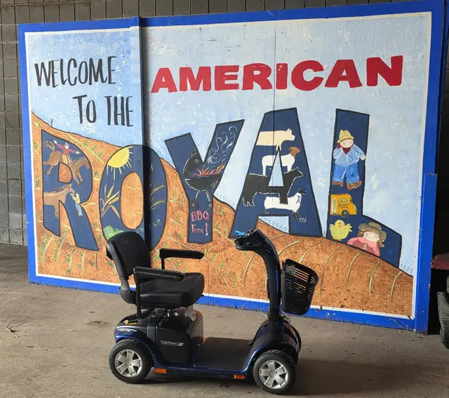 Mobility scooter from KC Mobility at American Royal sign in Kansas City