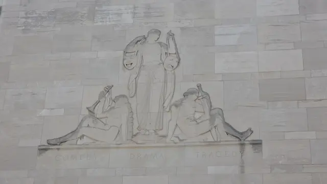 Mobility scooter rental at an art deco stone relief, Kansas City