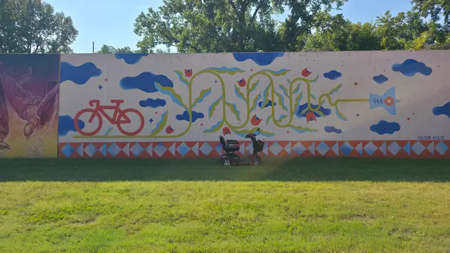Mobility scooter from KC Mobility at a bicycle and cloud mural in Kansas City