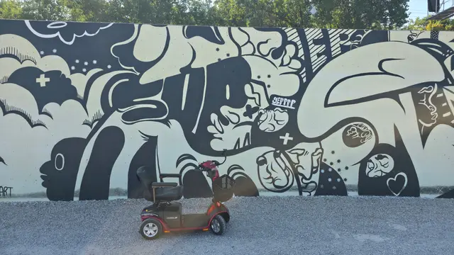 Mobility scooter from KC Mobility at a black and white doodle mural in Kansas City
