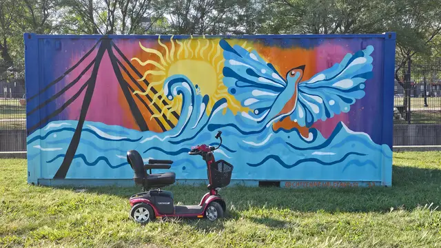 Accessible visit to a blue bird and wave mural with a mobility scooter rental, Kansas City