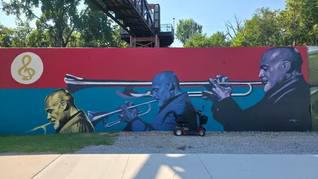 Accessible visit to a blue figures mural with a mobility scooter rental, Kansas City