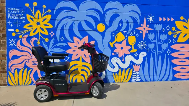 Mobility scooter from KC Mobility at a blue floral mural in Kansas City