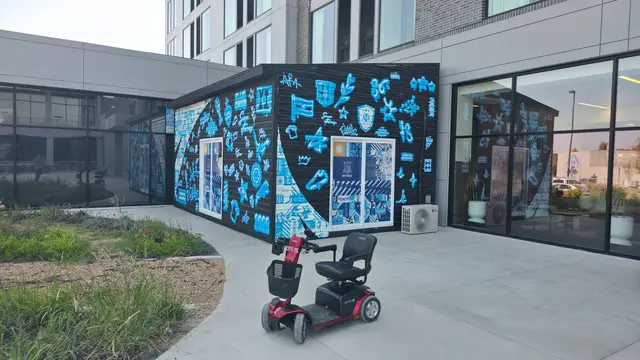 Mobility scooter rental on location at a blue mural building, Kansas City