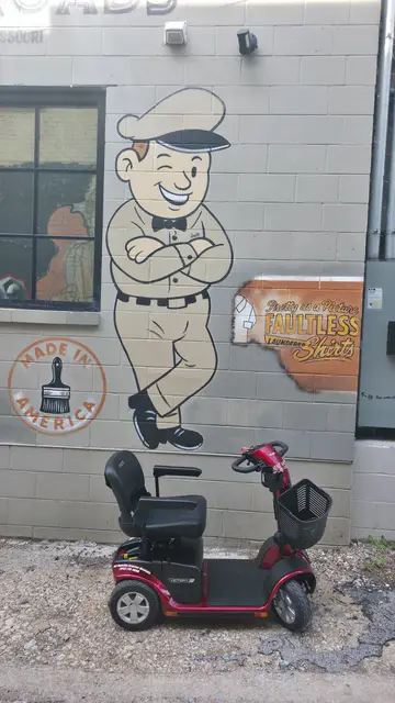 Mobility scooter rental on location at a cartoon figure mural, Kansas City