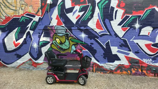 Mobility scooter from KC Mobility at a character graffiti in Kansas City