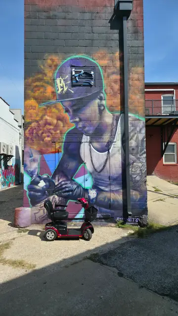Mobility scooter rental at a figurative mural, Kansas City