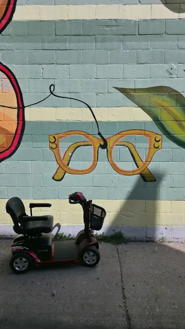 Mobility scooter rental on location at a giant eyeglasses mural, Kansas City