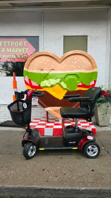 Mobility scooter rental on location at a giant hamburger sculpture, Kansas City