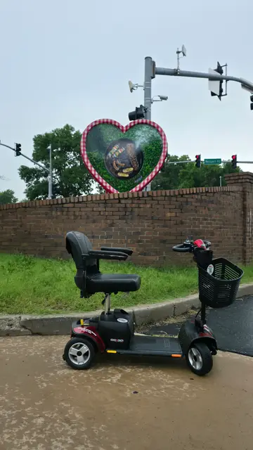Accessible visit to a heart decoration brick wall with a mobility scooter rental, Kansas City