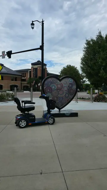 Mobility scooter rental on location at KC paisley heart sculpture, Kansas City