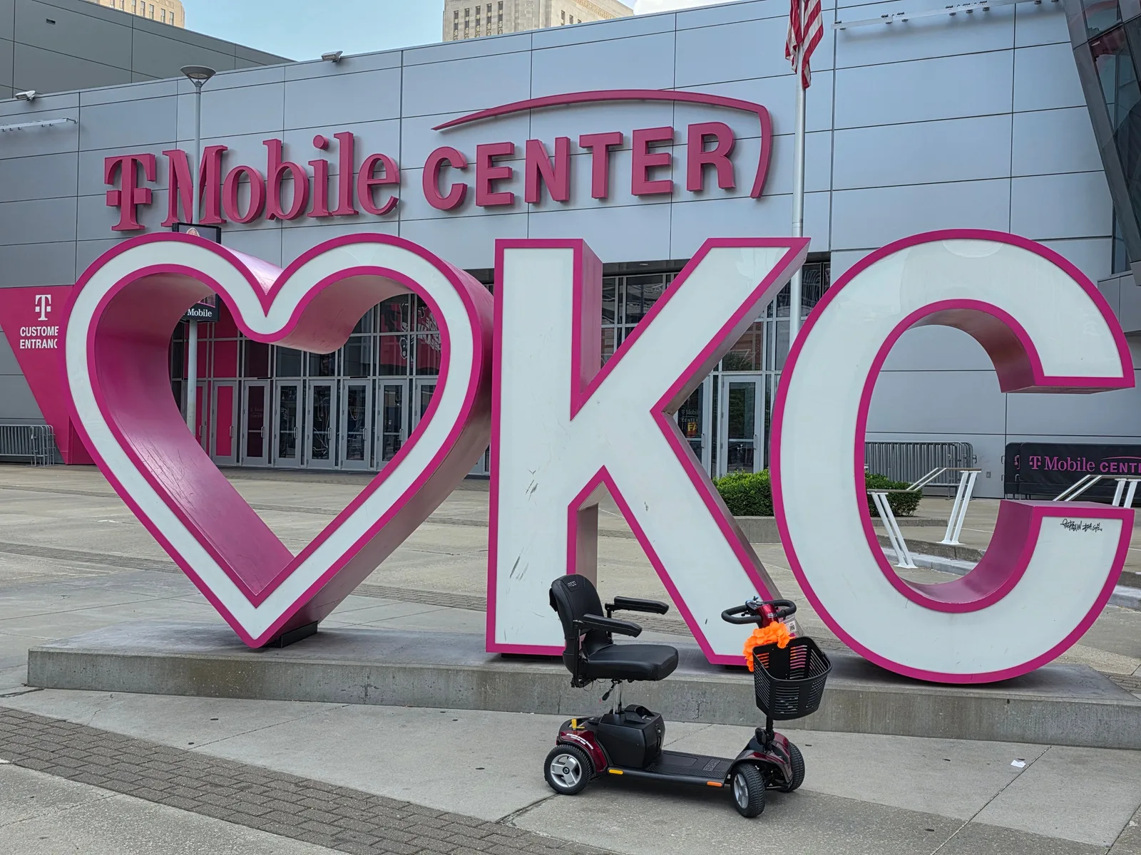 Mobility scooter rental parked at the LOVE KC sign outside T-Mobile Center in downtown Kansas City