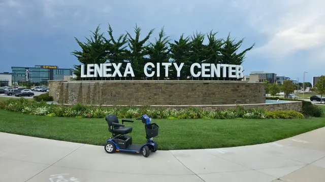 Accessible visit to Lenexa City Center sign with a mobility scooter rental, Lenexa