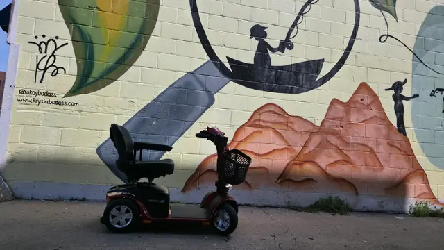 Accessible visit to a metal relief sculpture with a mobility scooter rental, Kansas City