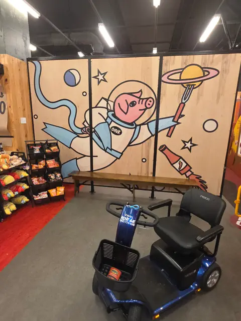 Mobility scooter rental at Museum of BBQ pig mural, Kansas City