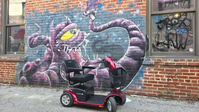 Mobility scooter rental on location at a pink snake mural, Kansas City