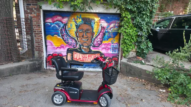 Mobility scooter rental at a portrait mural, Kansas City
