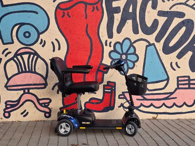 Mobility scooter from KC Mobility at a red motor mural in Kansas City