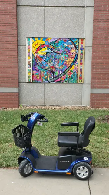 Mobility scooter rental on location at a stained glass style mural, Kansas City