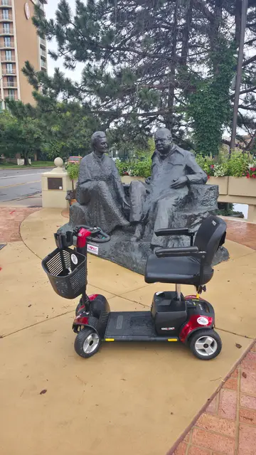 Mobility scooter rental on location at a stone monument sculpture, Kansas City
