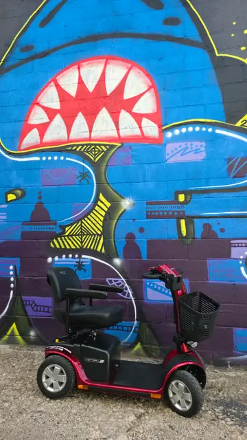 Mobility scooter rental at a street art wall, Kansas City