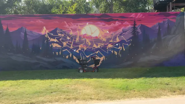 Mobility scooter rental at a sunset landscape mural, Kansas City