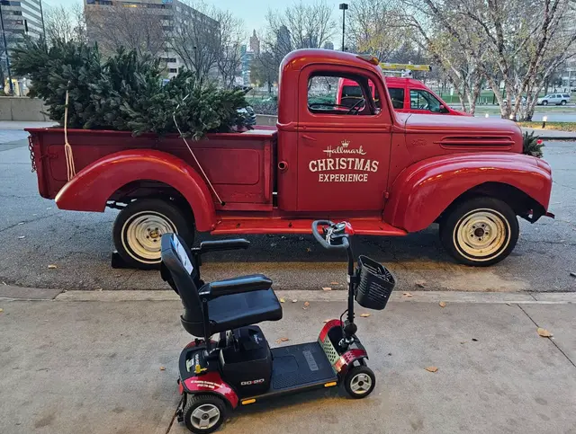 Accessible visit to a vintage christmas truck with a mobility scooter rental, Kansas City